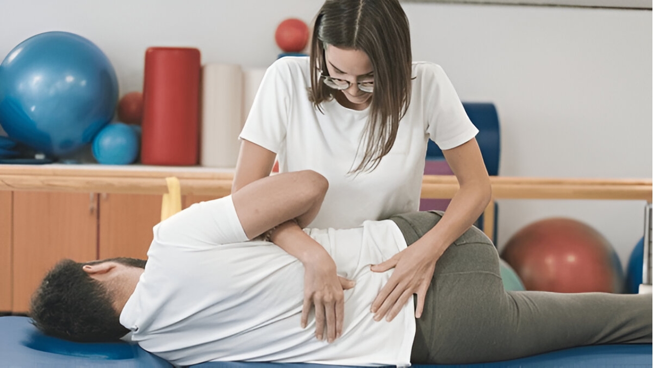 A chiropractor adjusts a patient's spine on a treatment table, representing services at a Chiropractor Ridgefield CT, Ridgefield Chiropractic & Wellness Center.