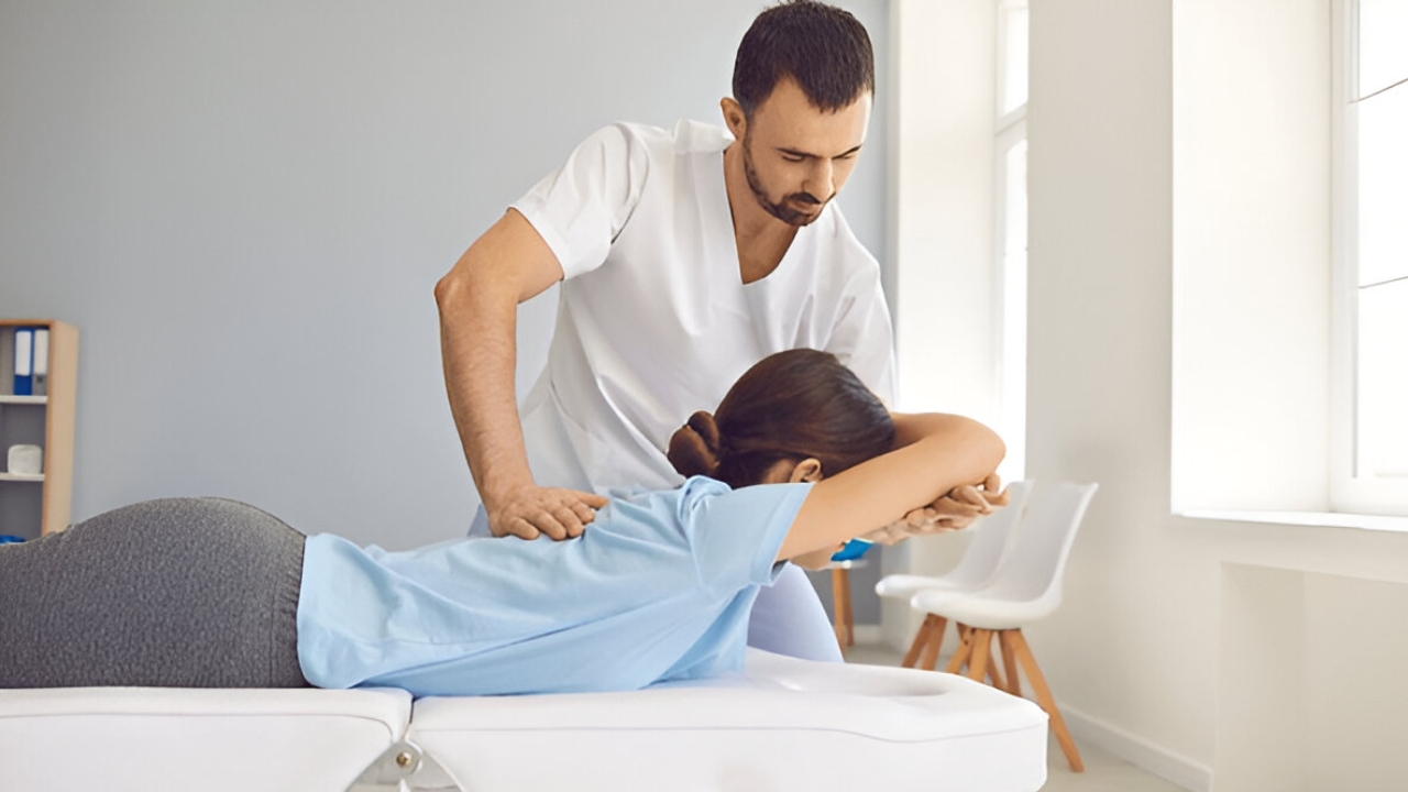 
A doctor at Ridgefield Chiropractic & Wellness Center adjusts a patient's back, providing services as a Chiropractor Ridgefield CT.